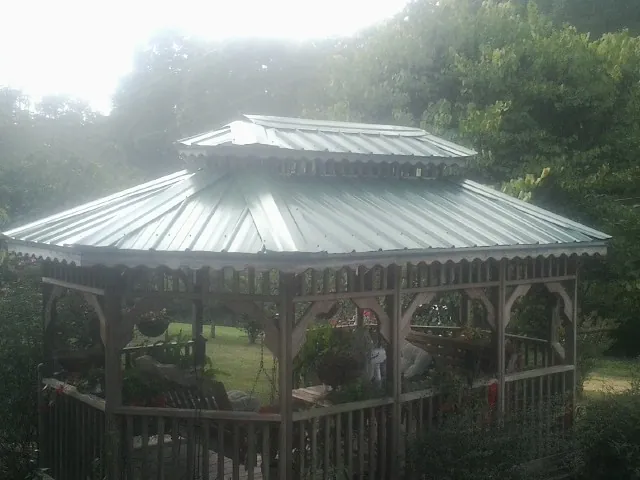 Two tier green metal roof on a garden gazebo in Pomfret Center